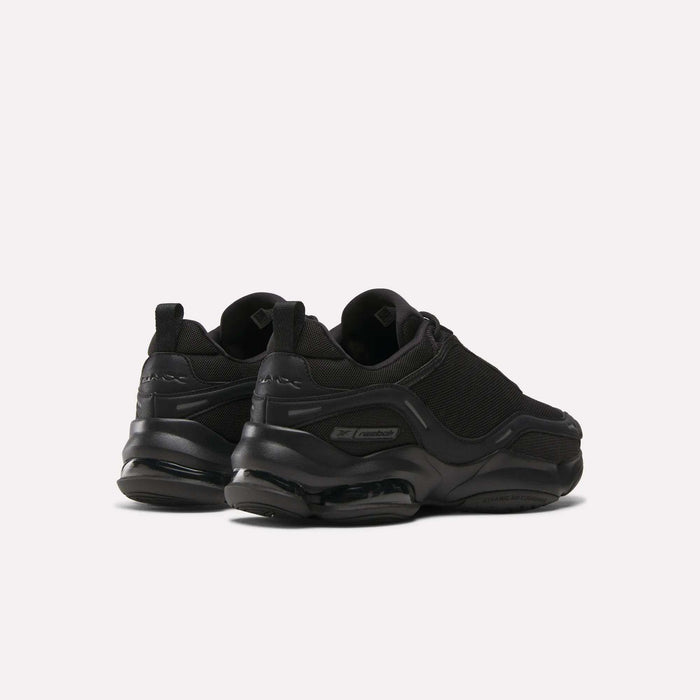 The Reebok DMX Series 3000 Shoes in black feature chunky soles with DMX moving air technology for exceptional comfort, shown from the back and side on a plain light background.