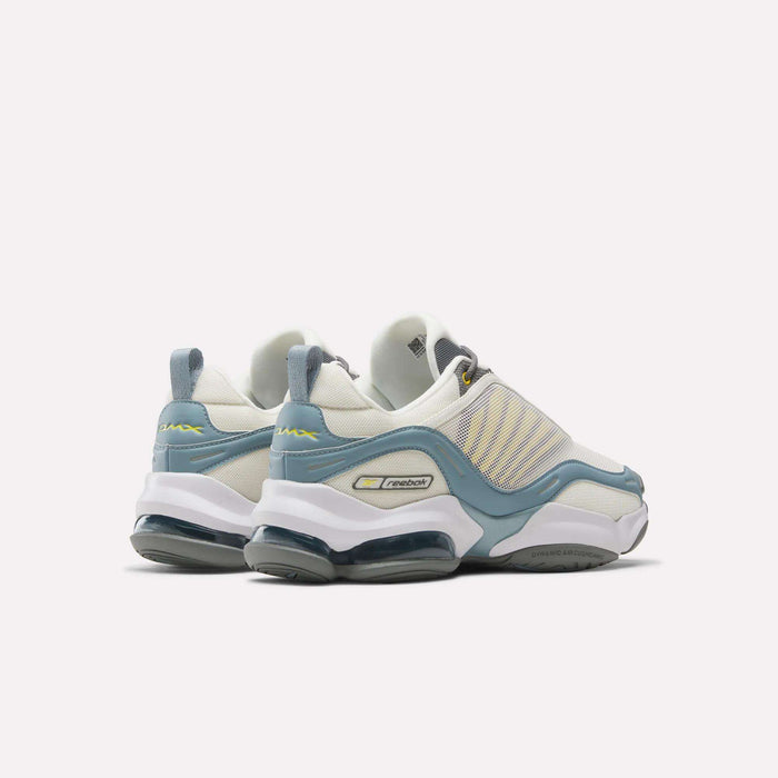 The Reebok DMX Series 3000 Shoes, shown in white with light blue and yellow accents, feature a chunky sole, mesh details, and DMX moving air technology for enhanced comfort. Displayed from the back and side on a plain white background.