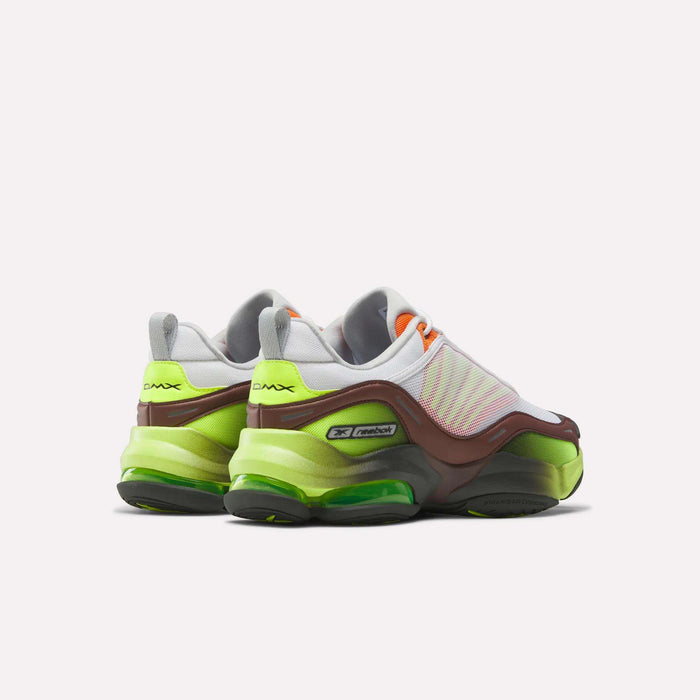 A pair of Reebok DMX Series 3000 Shoes with a chunky sole, in green, brown, white, and orange accents, shown on a white background with the heels facing forward for maximum comfort.