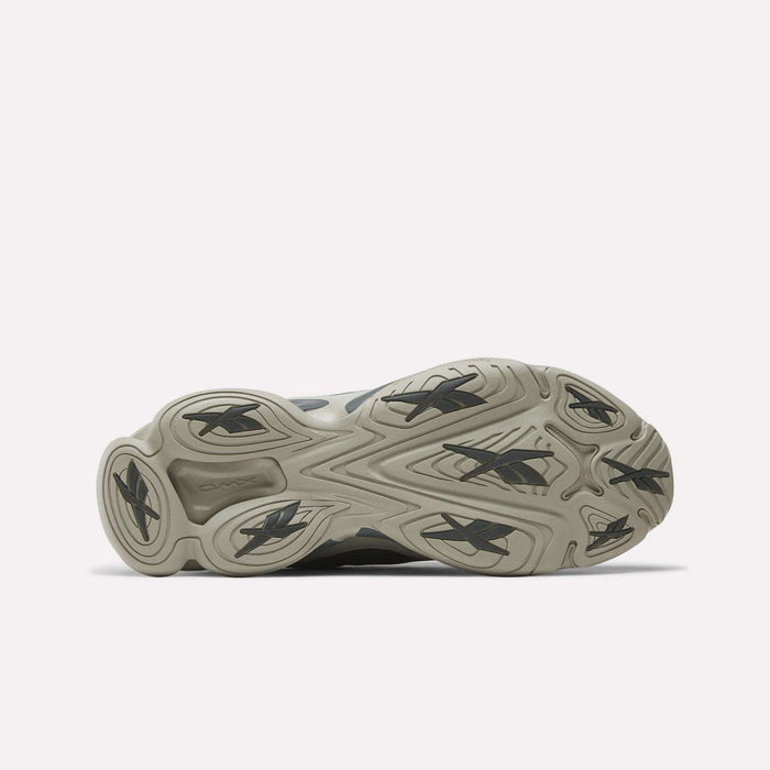 Bottom view of Reebok DMX Series 3000 Shoes with a light gray rubber outsole, multiple black Reebok logos, and a wavy tread pattern for traction and comfort, highlighting the brand’s innovative design.