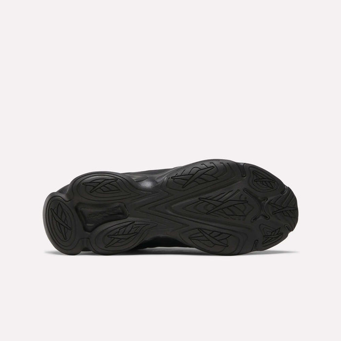 The image shows the black rubber outsole of the Reebok DMX Series 3000 Shoes, featuring DMX moving air technology and a wavy, textured tread pattern with decorative grooves visible on the sole.