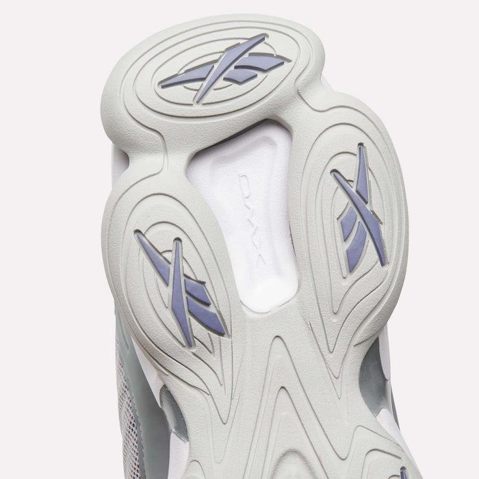 Close-up of the sole of the Reebok DMX Series 3000 Shoes, highlighting light gray and white hues with distinctive oval patterns and stylized X shapes in blue and gray rubber—demonstrating the signature comfort of Reebok footwear with DMX moving air technology.