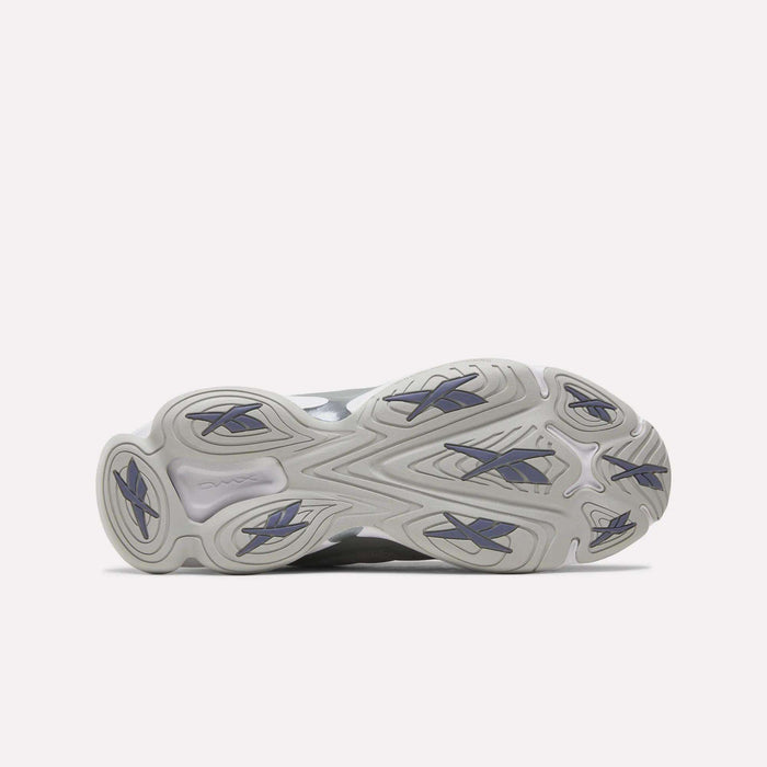 The image displays the outsole of the Reebok DMX Series 3000 Shoes, showcasing a wavy, textured light gray pattern with dark blue rubber traction accents against a white background. These shoes are engineered for comfort and enhanced grip, featuring innovative DMX moving air technology.