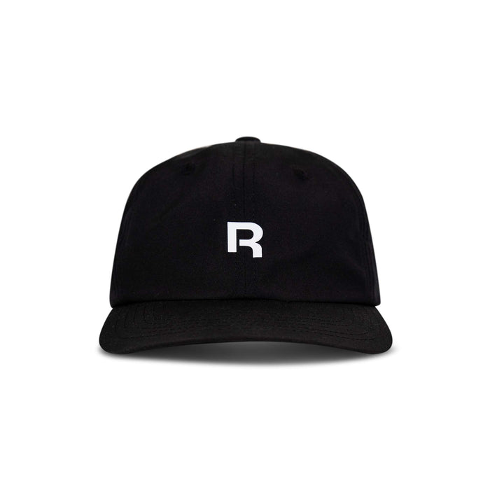 The Reebok Drop R Court Cap is a black baseball cap with a curved brim, showcasing a bold white "R" on the front. Photographed against a plain white background.