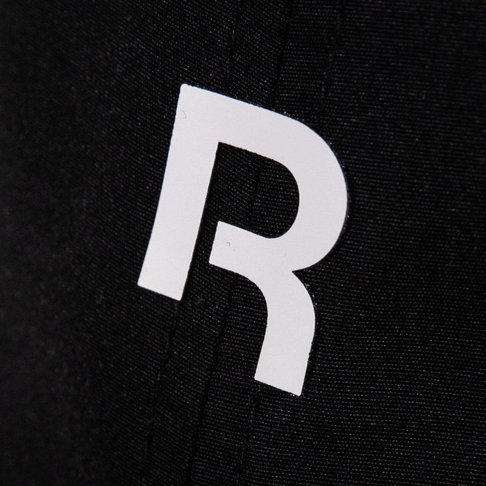 The Reebok Drop R Court Cap features a white, stylized letter R printed on black fabric, accented by visible vertical stitching.