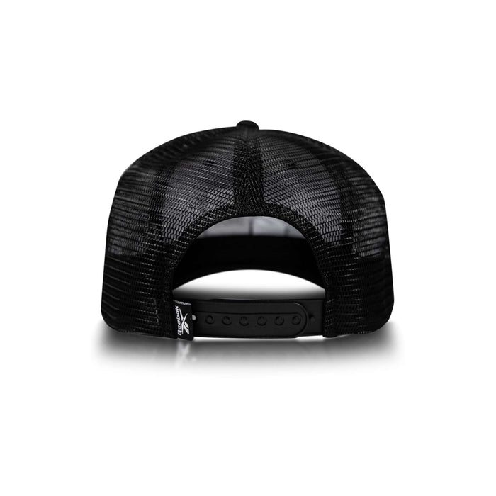 The Reebok Embroidered Vector Trucker Cap is shown from the back, displaying its black mesh, adjustable snapback closure, and a small tag on the lower left side against a white background.