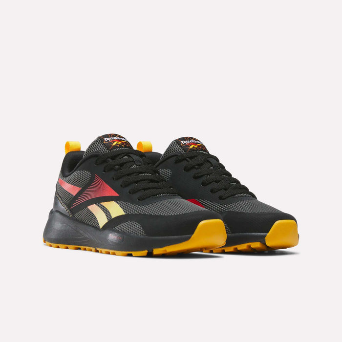 A pair of Reebok Energen Running Shoes for little kids, featuring a black design with red and yellow accents, black laces, a cushioned midsole, and yellow outsoles, displayed on a white background.