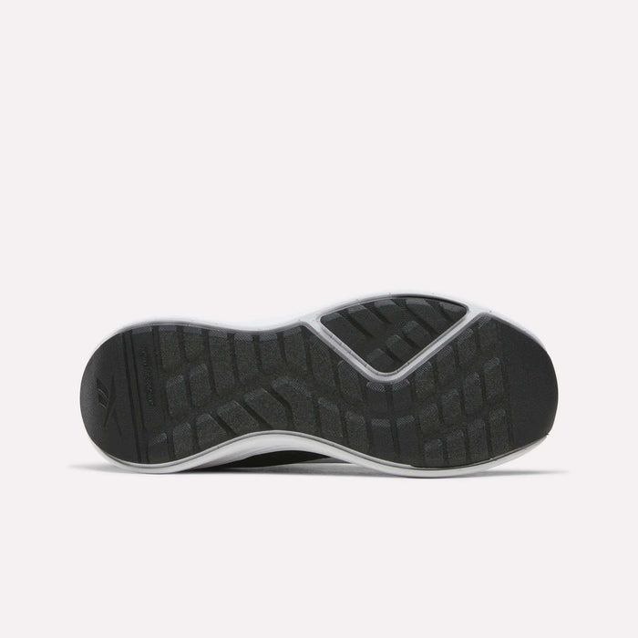 The image displays the black rubber sole of the Reebok Energen Running Shoes for little kids, viewed from below. Designed for durability and support, the sole features textured, rectangular grip patterns and a white outer edge to provide optimal traction—making them ideal running shoes for kids.