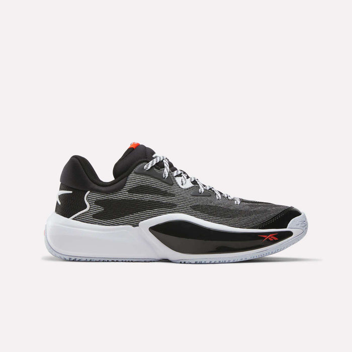 Introducing the Reebok Engine A 26 Basketball Shoes in black, white, and red—a low-top sneaker featuring an engineered mesh upper, black and white sole, white laces, and a subtle red Reebok logo on the side. Designed for speed on the court, these athletic shoes are perfect for anyone seeking performance-driven Reebok basketball footwear.