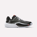 Introducing the Reebok Engine A 26 Basketball Shoes in black, white, and red—a low-top sneaker featuring an engineered mesh upper, black and white sole, white laces, and a subtle red Reebok logo on the side. Designed for speed on the court, these athletic shoes are perfect for anyone seeking performance-driven Reebok basketball footwear.