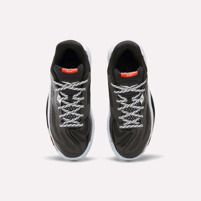 A pair of Reebok Engine A 26 Basketball Shoes in black, featuring a breathable engineered mesh upper, white laces, and orange tongue labels, displayed from an overhead perspective on a white background.