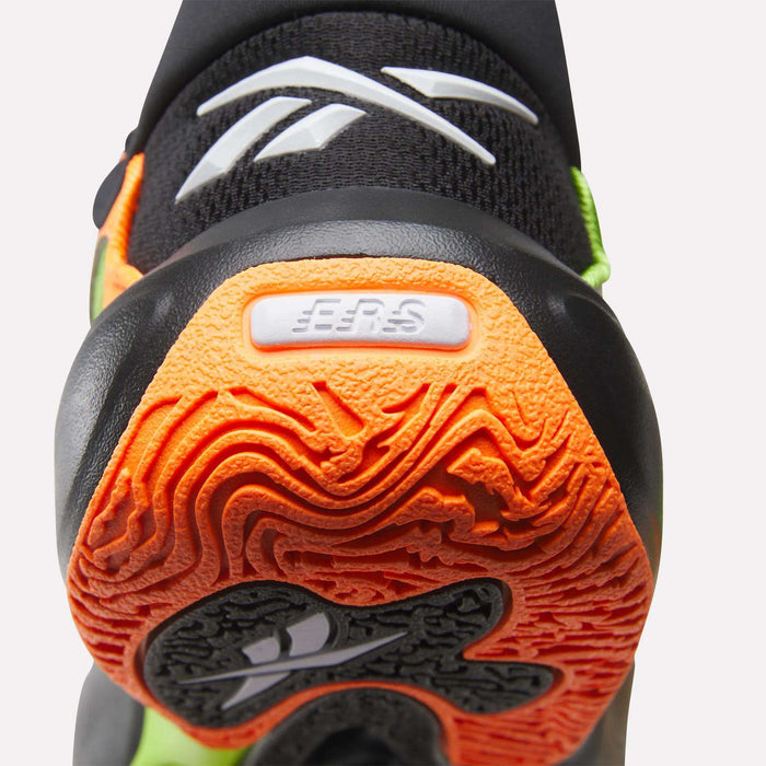 Close-up of the heel of a Reebok Engine A 26 Basketball Shoe, highlighting its textured orange and black energy-return sole, EER8 on a raised white label, and a white Reebok logo on the black upper.