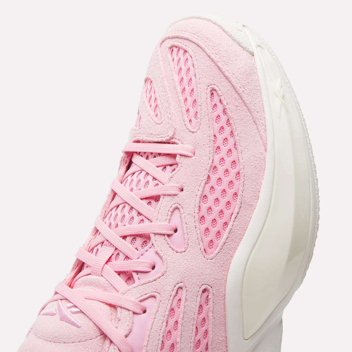 A close-up of the Reebok Engine A 26 Basketball Shoes in pink, showcasing mesh and suede textures, pink laces, and a white sculpted sole designed for enhanced stability.