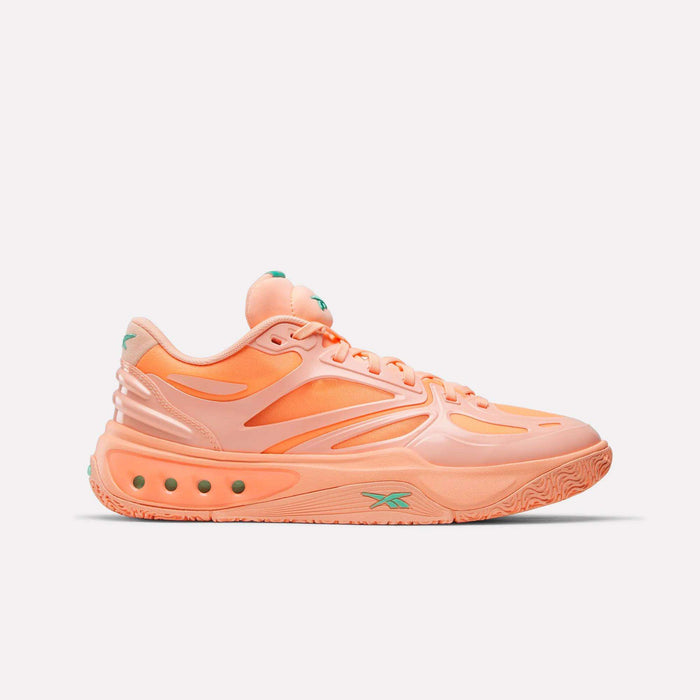 The Reebok Engine A Basketball Shoes feature a peach color with green accents, a chunky sole, and SuperFloat foam cushioning. Shown in side profile against a plain white background, these sneakers offer a sleek, modern look.