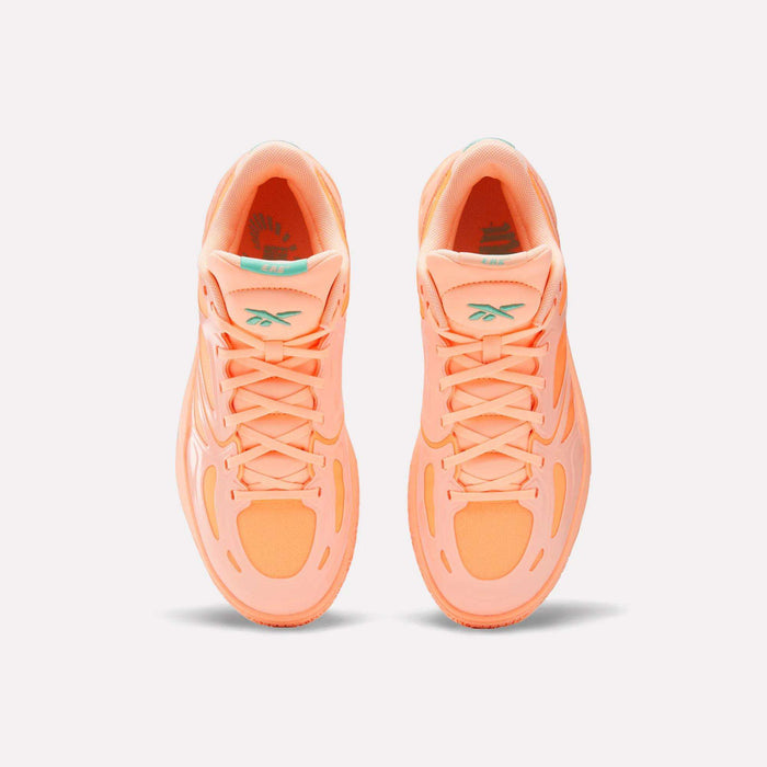 Top view of bright orange Reebok Engine A Basketball Shoes with ERS technology for energy return and light teal tongue logos, set against a plain white background.