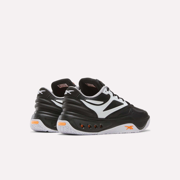 A pair of Reebok Engine A Pump Shoes in black and white with striking orange accents, showcasing advanced Pump technology inspired by performance basketball footwear, displayed from the back and side on a plain light background.