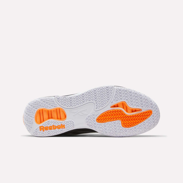 The image displays the sole of a Reebok Engine A Pump Shoe, showcasing a white and orange pattern with textured treads designed for enhanced grip—perfect for performance basketball. The orange Reebok logo appears on the left side of the sole.