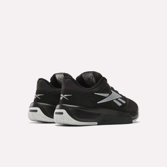 A pair of Reebok Engine LT Shoes in black and white with silver accents, shown from the back and side on a plain light background.