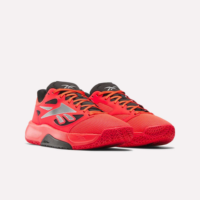 A pair of Reebok Engine LT Shoes in bright red with black and gray accents, black soles, and white Reebok logos on the sides, displayed against a plain light background.
