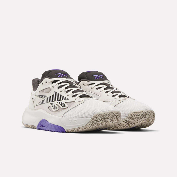 The Reebok Engine LT Shoes are white sneakers with black and purple accents, textured soles, and a geometric side design. Displayed on a plain white background, they offer cushioned comfort and stylish support for active wear.