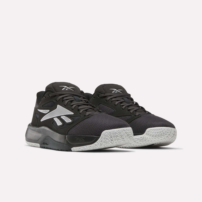 A pair of Reebok Engine LT Shoes with black mesh uppers, white textured soles, and bold white Reebok logos on the sides, shown on a plain light background.