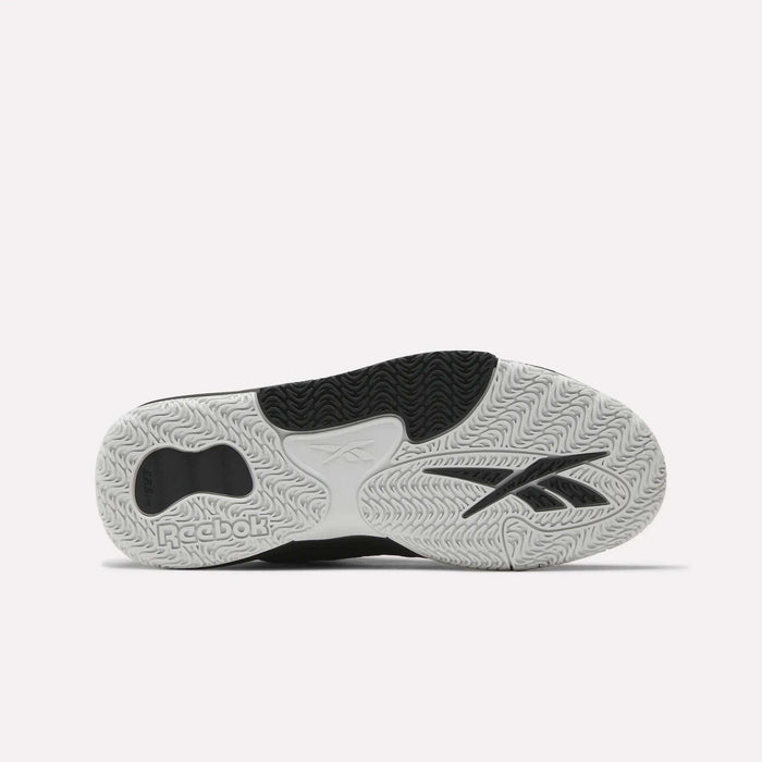 The image shows the sole of Reebok Engine LT Shoes, featuring a textured white, black, and grey rubber outsole with various tread patterns and the Reebok logo clearly visible.