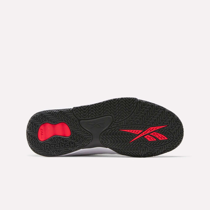 The image shows the black outsole of Reebok Engine LT Shoes featuring textured wavy patterns, a red Reebok logo, and a small red heel insert, all set against a plain white background.