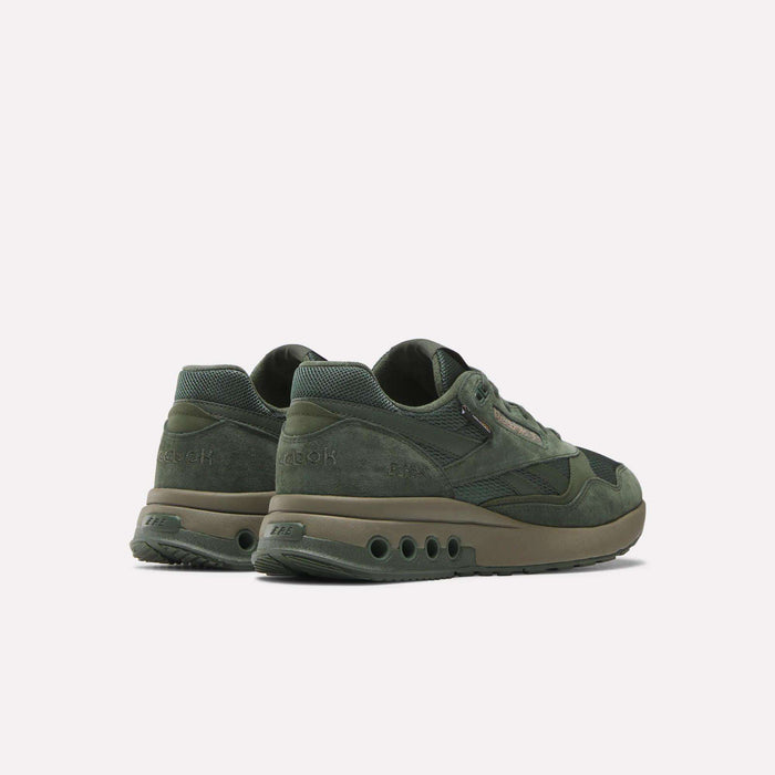 A pair of green Reebok ERS World Shoes with suede texture, midsole air holes, and Reebok embossed on the heel. The shoes are shown angled to display the back and side views against a plain white background.