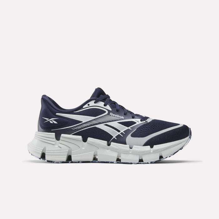 The Reebok FloatZig 2 Running Shoes in navy blue and white feature a chunky, segmented Superfloat+ cushioned sole, a breathable mesh upper, and a white Reebok logo on the side, displayed against a plain white background.