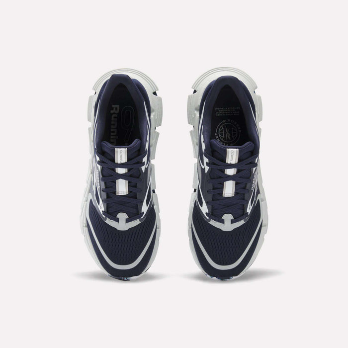 A pair of Reebok FloatZig 2 Running Shoes in navy blue and white are shown from above on a white background. They feature mesh uppers, Superfloat+ cushioning, white accents, and chunky white soles.