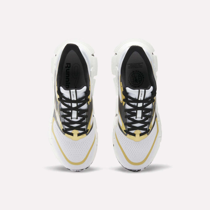 Top view of a pair of Reebok FloatZig 2 Running Shoes in white with black and yellow accents, Superfloat+ cushioning for energy return, black laces, and "Running" on the insole, placed side by side on a light background.