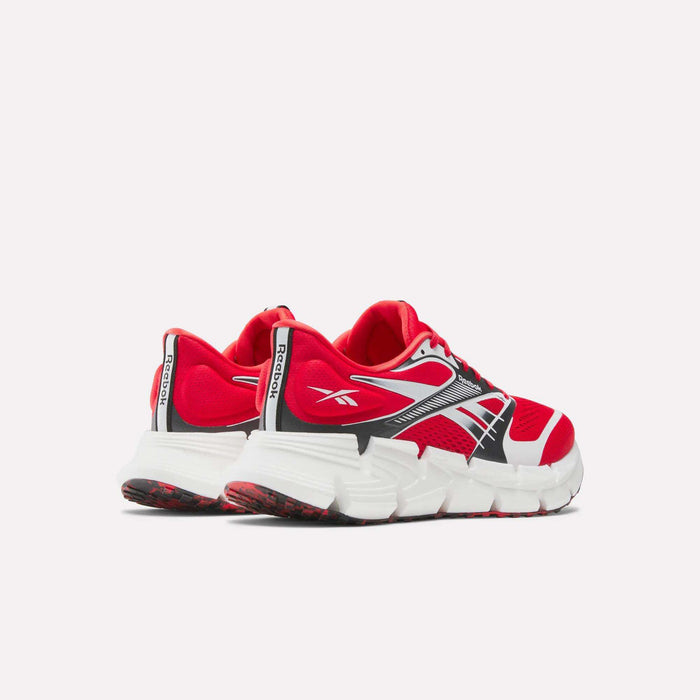 A pair of red Reebok FloatZig 2 Running Shoes with Superfloat+ cushioning, white and black accents, chunky white soles, black and white side stripes, and “Reebok” branding on the heel and side, shown angled to display back and side.