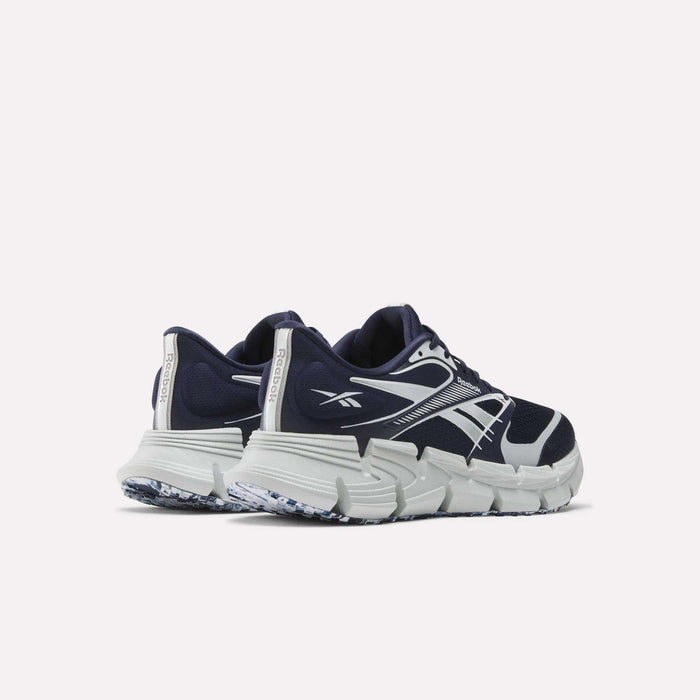 A pair of Reebok FloatZig 2 Running Shoes in navy blue and white, featuring thick textured soles and Superfloat+ cushioning, shown from the back and side on a plain white background.