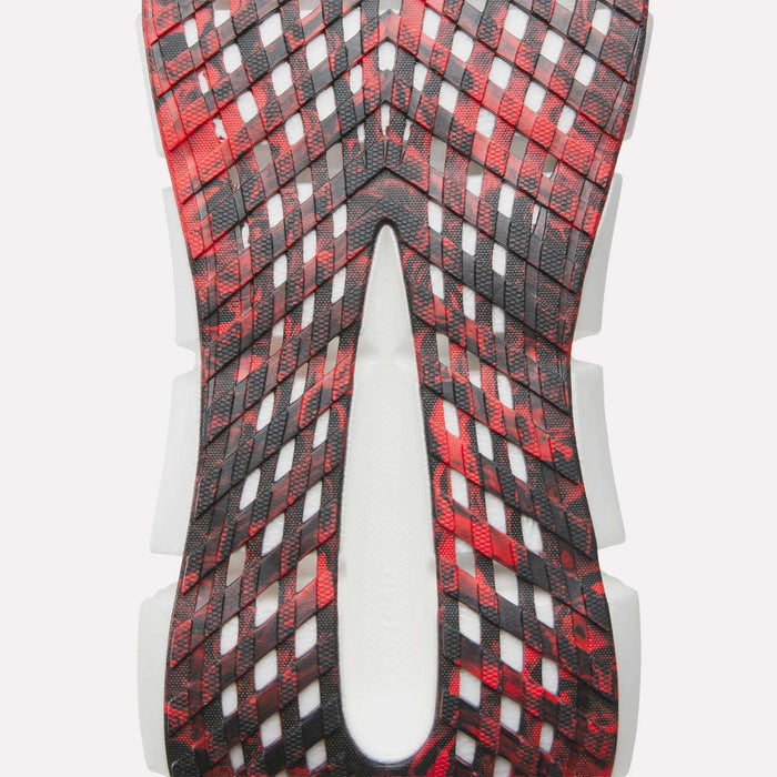 Close-up of the Reebok FloatZig 2 Running Shoe sole, showcasing a red and black lattice pattern with white accents beneath, highlighting its unique texture, design, and advanced Superfloat+ cushioning.