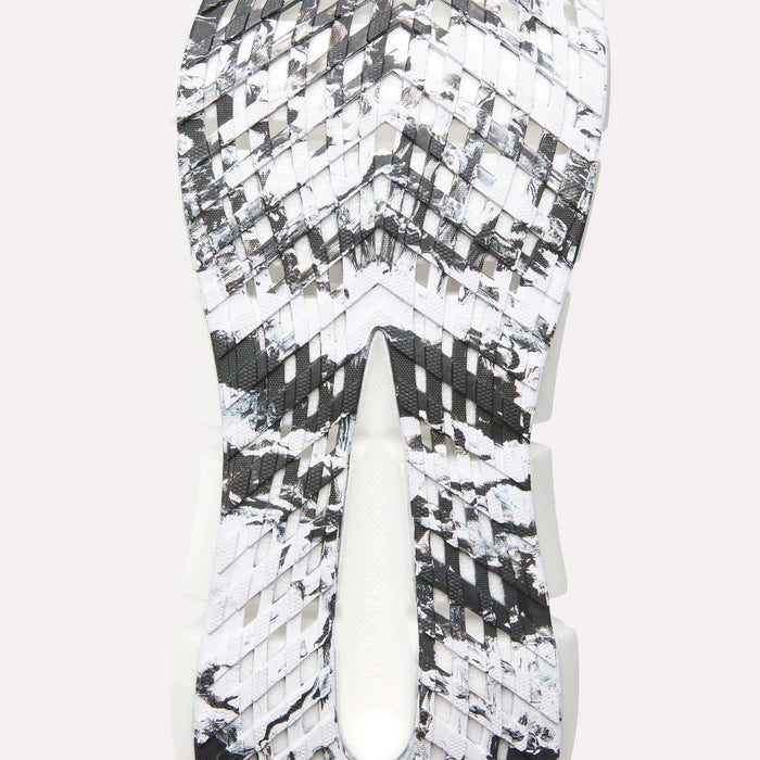 Close-up of the Reebok FloatZig 2 Running Shoes sole featuring a black, white, and gray marbled pattern, textured angular grooves for traction, and Superfloat+ cushioning for responsive comfort.