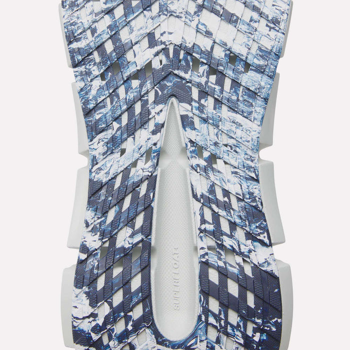 Close-up of the textured sole of Reebok FloatZig 2 Running Shoes, showing a geometric cut-out pattern in dark blue, white, and gray with “SUPERFOAM” embossed on the white center, highlighting Superfloat+ cushioning for running.