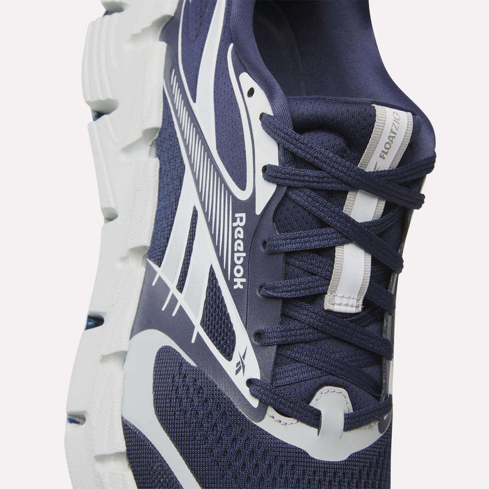 Close-up of Reebok FloatZig 2 Running Shoes in navy blue with white accents, showcasing a chunky white Superfloat+ cushioned sole and visible FLOATZIG and Reebok branding on the tongue and side.