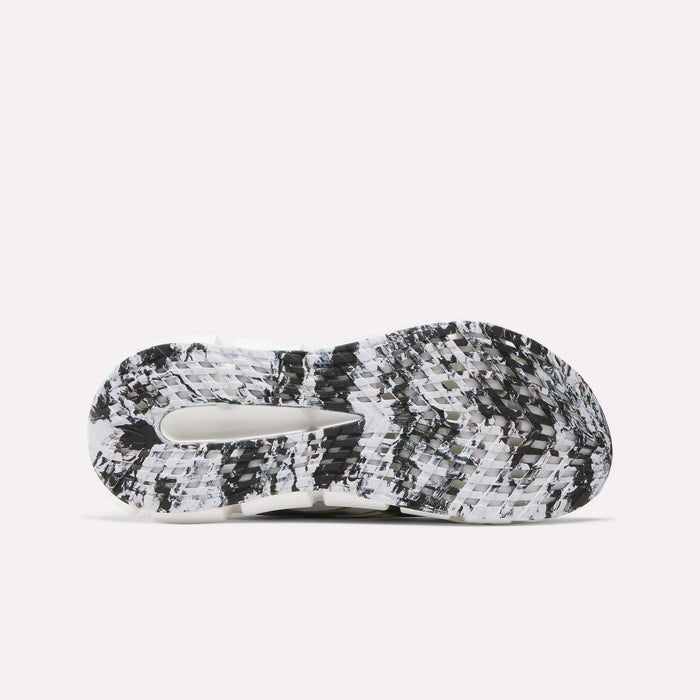 The image displays the sole of Reebok FloatZig 2 Running Shoes, featuring a black, white, and grey marbled pattern with textured treads, a central cutout for enhanced grip, and Superfloat+ cushioning.