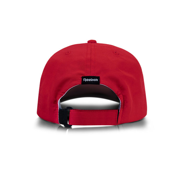 The Flow Cap by Reebok is a red baseball cap seen from the back, with an adjustable strap and a small black Reebok logo tag above the strap.