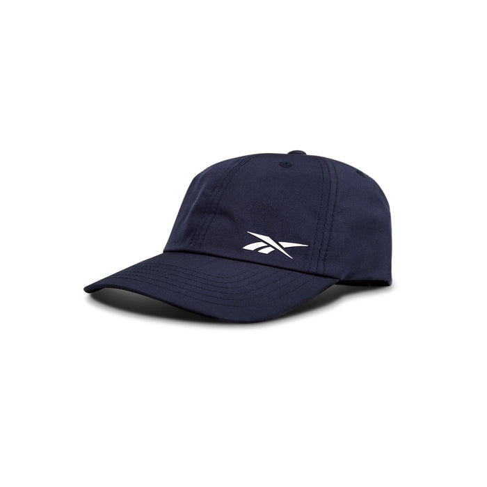 The Reebok Flow Cap in navy blue is made from recycled polyester, features a white logo on the front, and includes a moisture-wicking sweatband. It is shown angled against a plain white background.