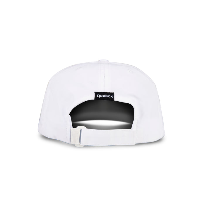 The Reebok Flow Cap in white is shown from the back, with an adjustable fabric strap and buckle, a black Reebok logo tag above the opening, and a moisture-wicking sweatband for comfort.