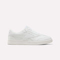 A white Reebok Forte Pitch Shoe for big kids, featuring a low-top silhouette, lace-up closure, and subtle stitched accents is displayed from the side against a plain light backdrop—a contemporary update on court-inspired footwear.