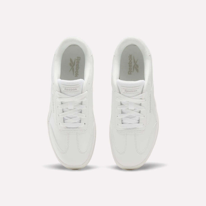 A pair of Reebok Forte Pitch Shoes - Big Kids in white, seen from above, featuring classic laces and the Reebok logo on the insoles. These court-inspired sneakers deliver timeless style and everyday comfort.