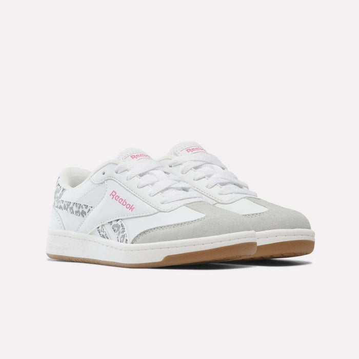 A pair of Forte Pitch Shoes - Big Kids from Reebok, featuring a white base with light gray suede accents, pink Reebok branding, leopard print detailing on the sides and heel, white laces, and gum-colored soles set against a plain background—these sneakers effortlessly blend classic style with bold details.