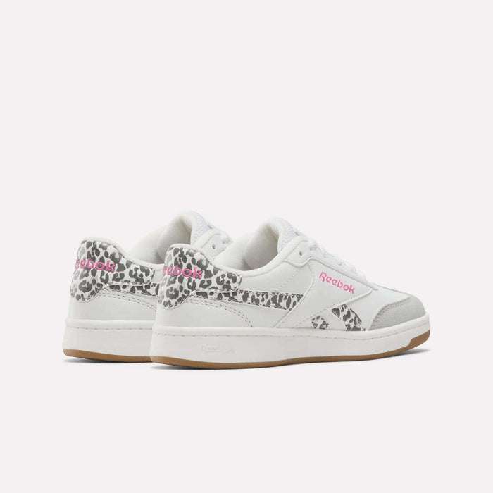 A pair of Reebok Forte Pitch Shoes - Big Kids in white, featuring grey accents, pink Reebok logos, and leopard print details on the heel and sides, displayed on a plain white background.