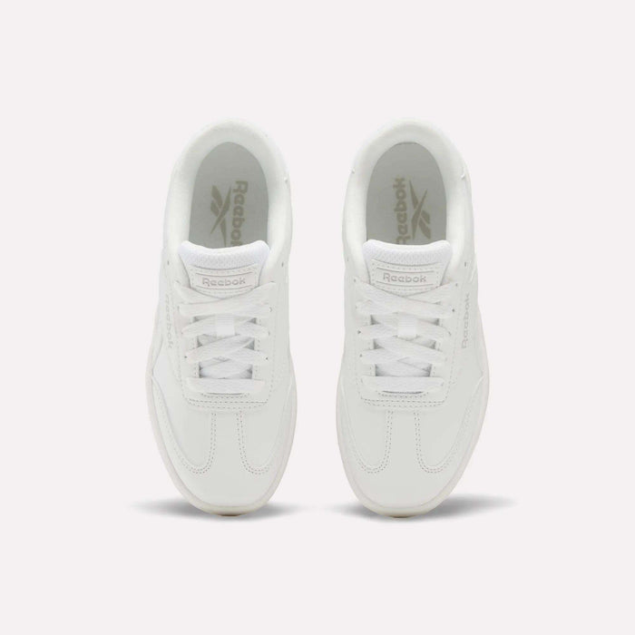 Top view of a pair of white Reebok Forte Pitch Shoes - Little Kids with white laces, placed side by side on a light background, highlighting their classic tennis-inspired style.