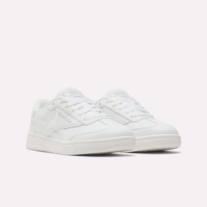 A pair of Reebok Forte Pitch Shoes for little kids, featuring a low-top, tennis-inspired design in white with matching white laces and subtle Reebok branding on the sides and tongue, set against a plain white background.