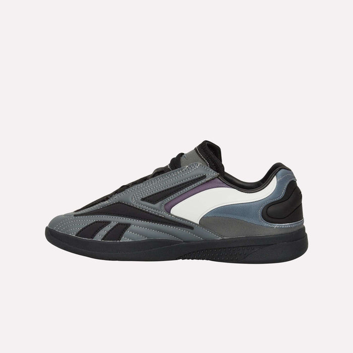 A low-top athletic sneaker in gray, black, and white with purple accents, the Reebok Hammer Pro LTD Shoes showcase a faux leather upper and are displayed in a side profile against a plain white background.