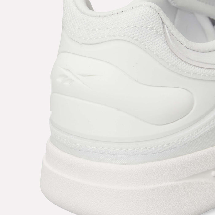 Close-up of the back and side of a white Reebok Hammer Pro LTD Shoe, highlighting its textured fabric, smooth and durable rubber sole, and a subtly embossed Reebok logo.