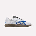 The Reebok Hammer Valde Shoes are white indoor soccer boots with a leather upper, blue, silver, and black accents, gum rubber sole, and black laces shown in side profile on a plain white background.